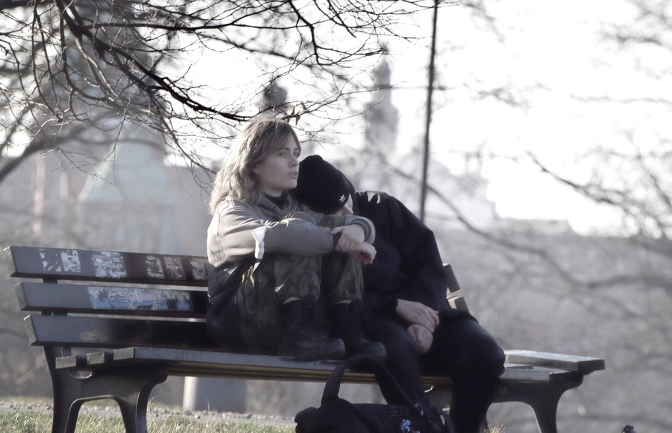 A picture of a young couple on a bench
